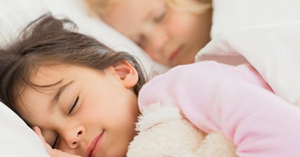 Children sleeping with teddy bear